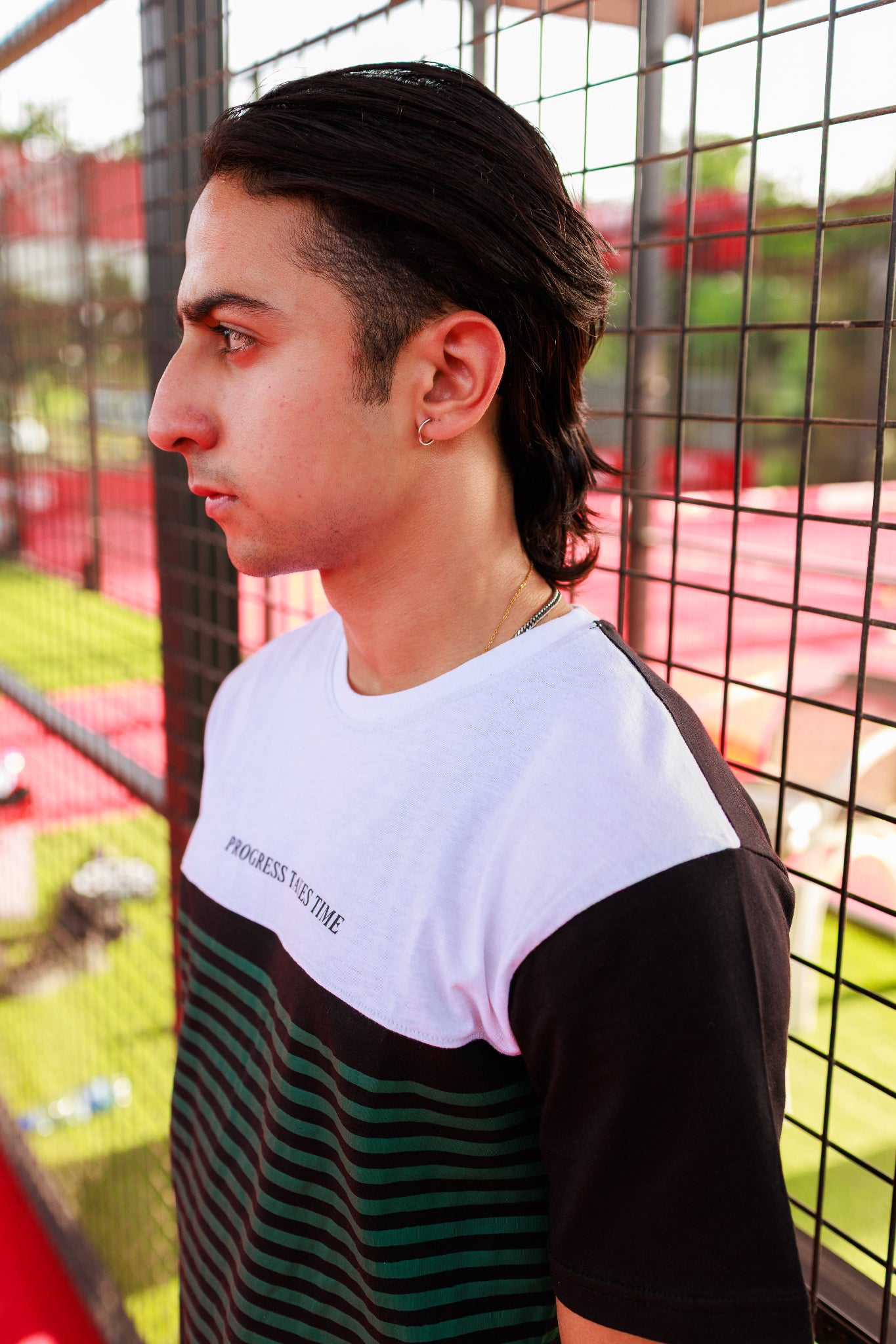 Person wearing a black and white striped shirt with a blurred background