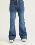 A pair of medium blue bootcut denim jeans with scope pockets, fly with zipper and metallic button.