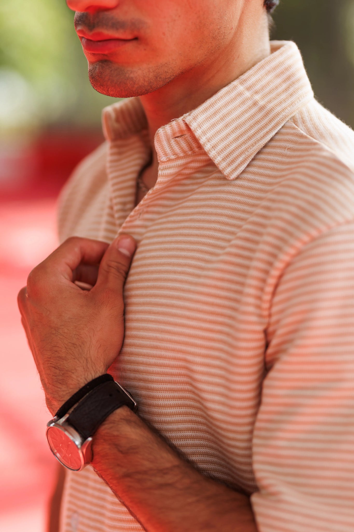 Man wearing a striped shirt with a blurred background