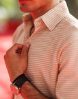 Man wearing a striped shirt with a blurred background