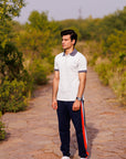 Man standing on a stone path with greenery in the background