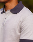 Close-up of a person wearing a striped polo shirt with a collar.