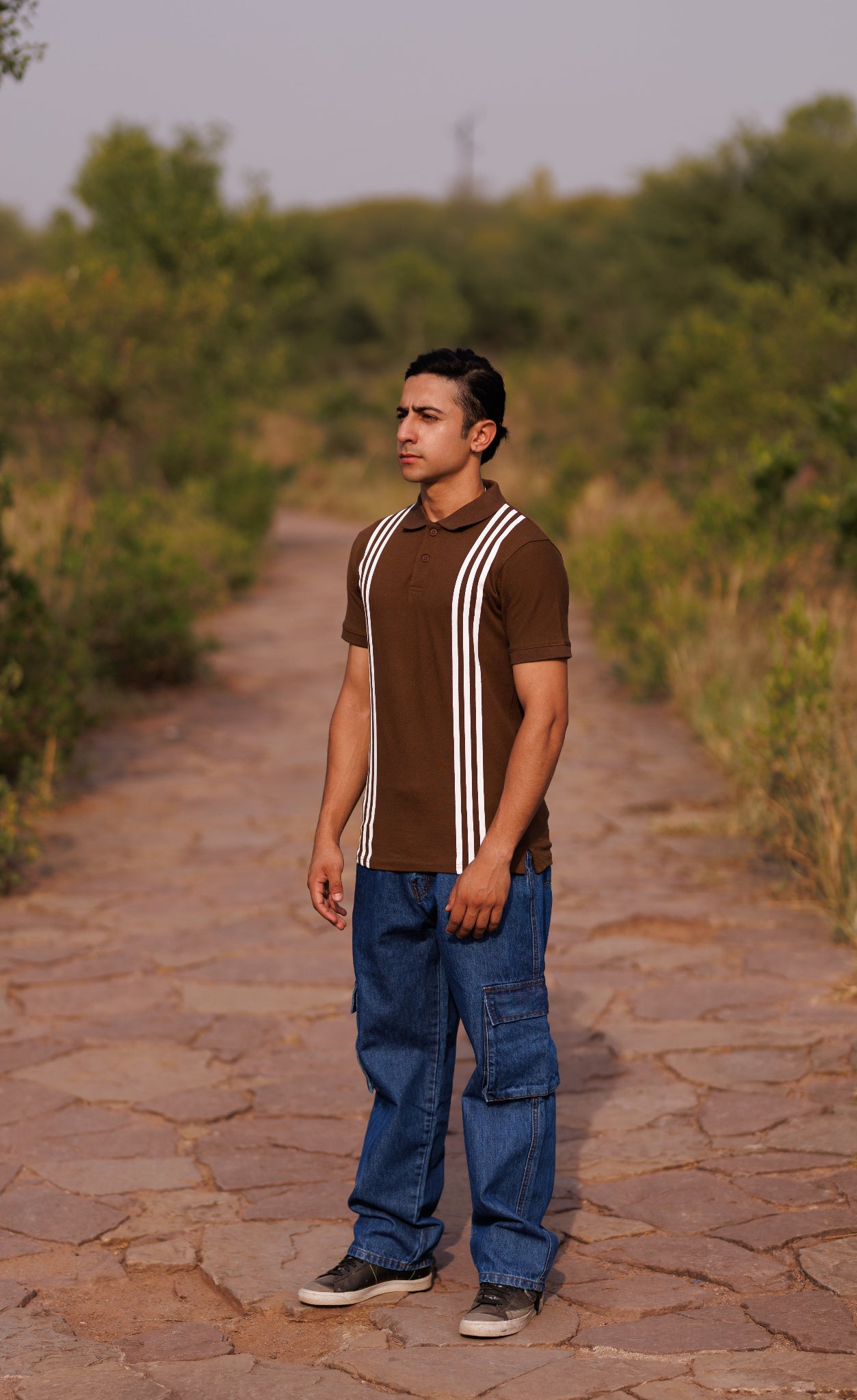 Man standing on a stone path in a natural setting