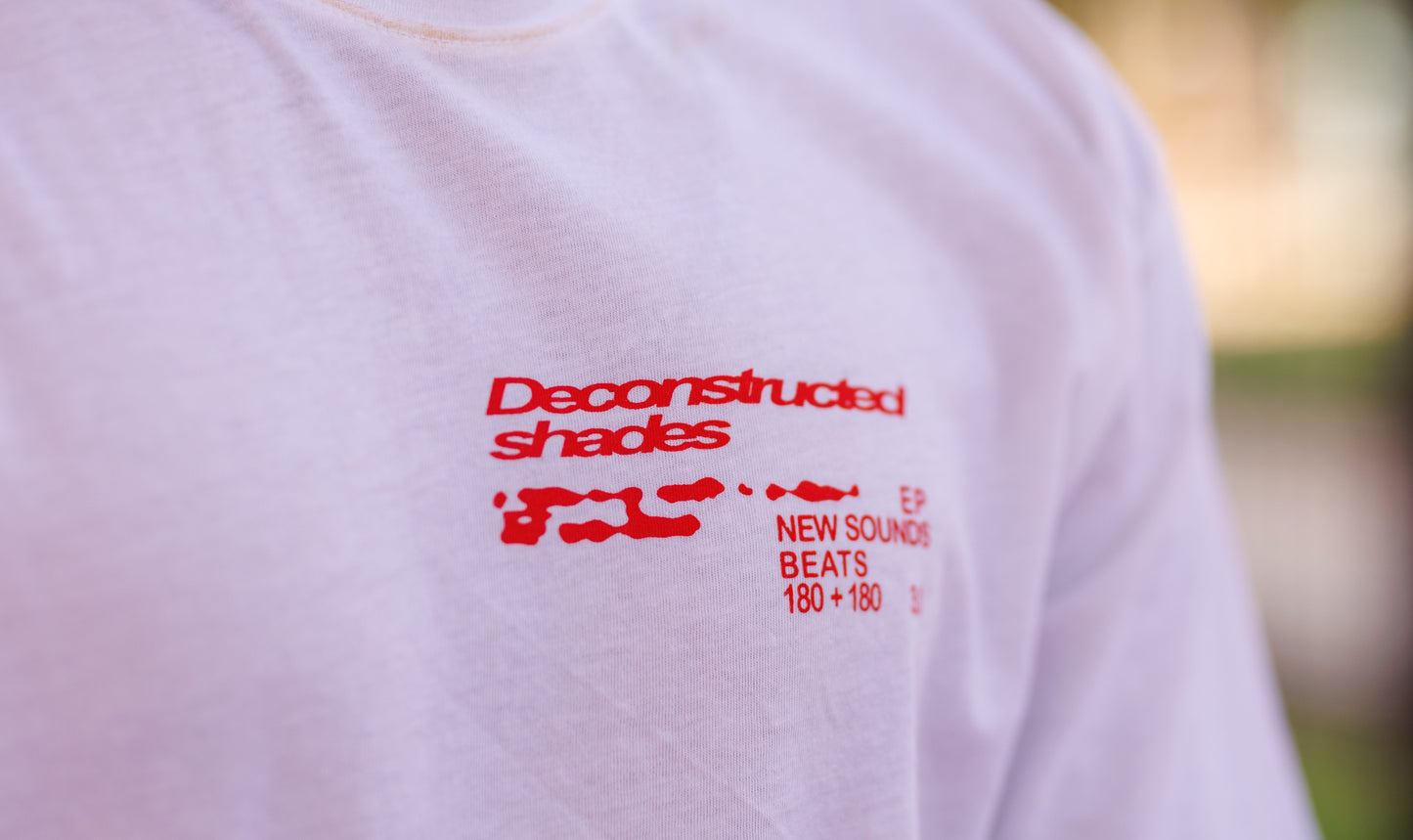 White t-shirt with red text on a blurred background