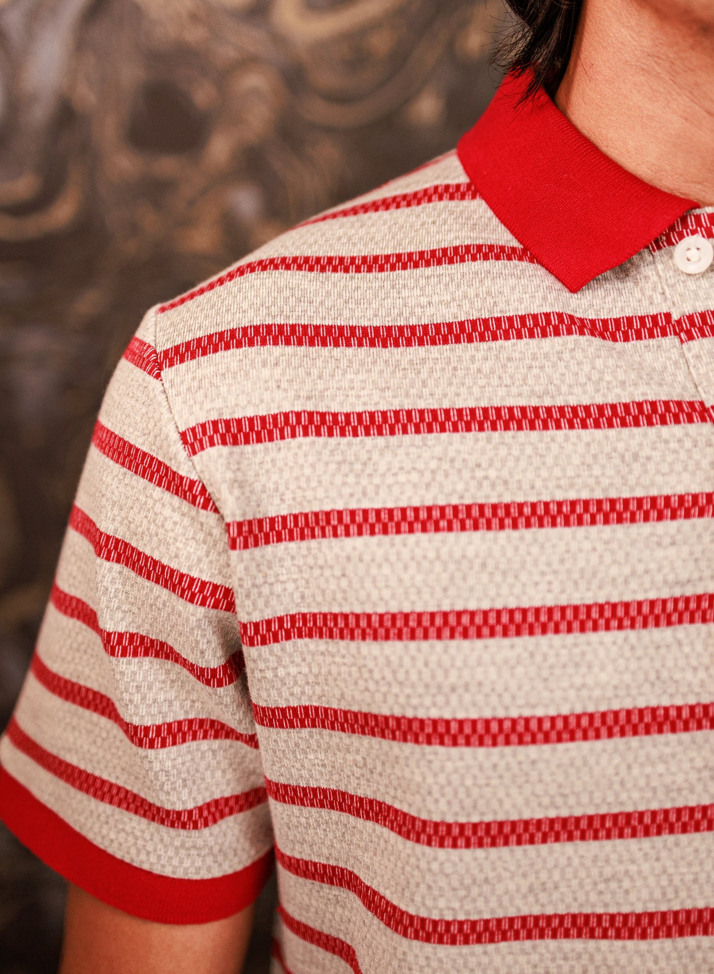 Red and white striped shirt with a close-up on a textured background