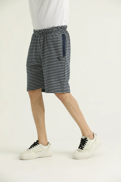A pair of striped cotton shorts with an elasticated waistband and side pockets on a male model.