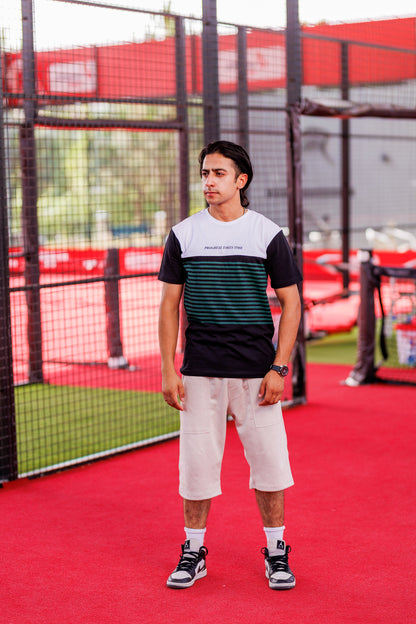 Person standing on a red sports court with a net in the background
