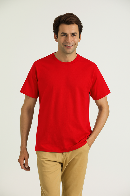 Man wearing a red t-shirt and beige pants on a white background