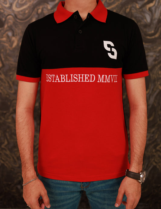 Person wearing a black and red polo shirt with 'S' logo and 'ESTABLISHED MMVII' text.