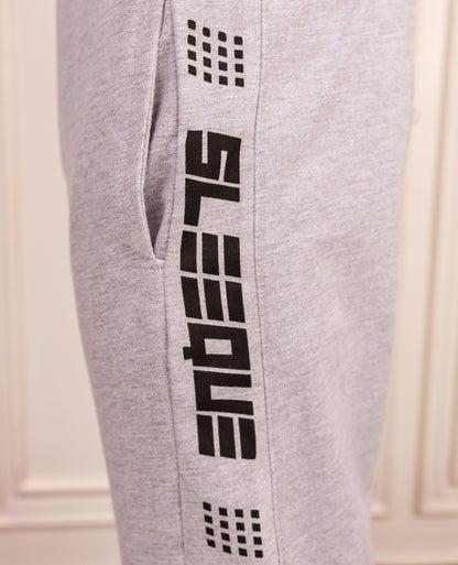 Gray sweatpants with black branding on a white background