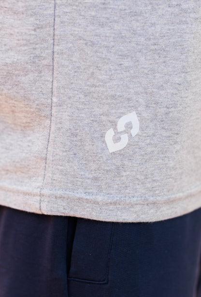 Close-up of a gray garment with a white logo on a navy background