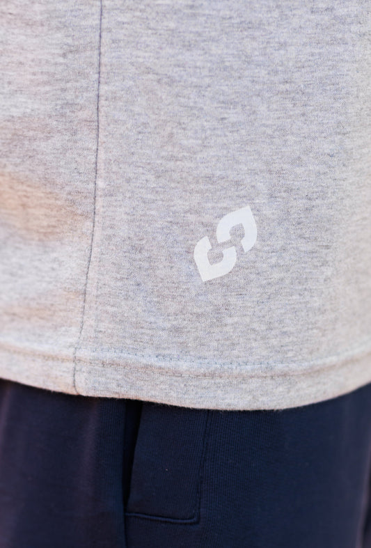 Close-up of a gray garment with a white logo on a navy background