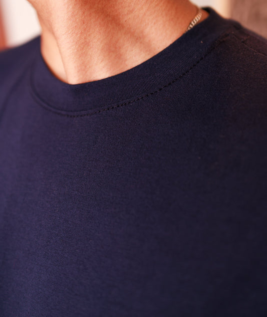 Close-up of a navy blue shirt collar with a blurred background