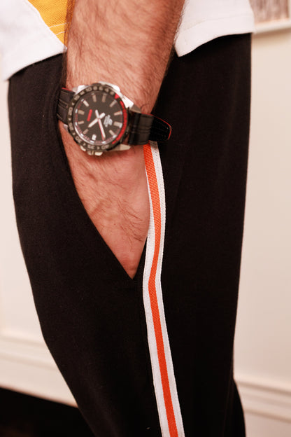 Person wearing a black watch on a white background