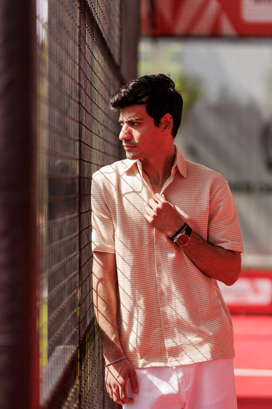 Man standing against a wall with a blurred background