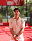 Man standing on a red sports court with a blurred background
