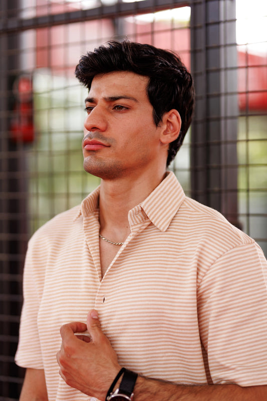 Man wearing a striped shirt with a blurred background