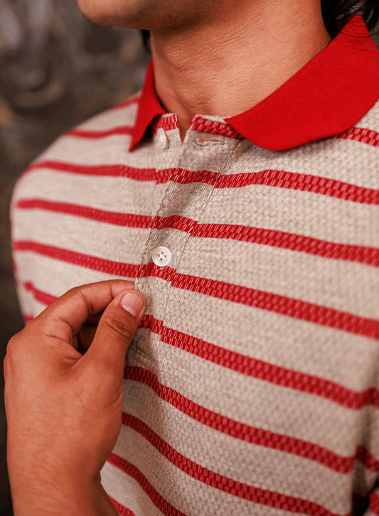 Close-up of a person wearing a red and white striped shirt with a blurred background